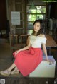 A woman sitting on top of a wooden box.