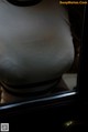 A close up of a woman's breasts in a mirror.